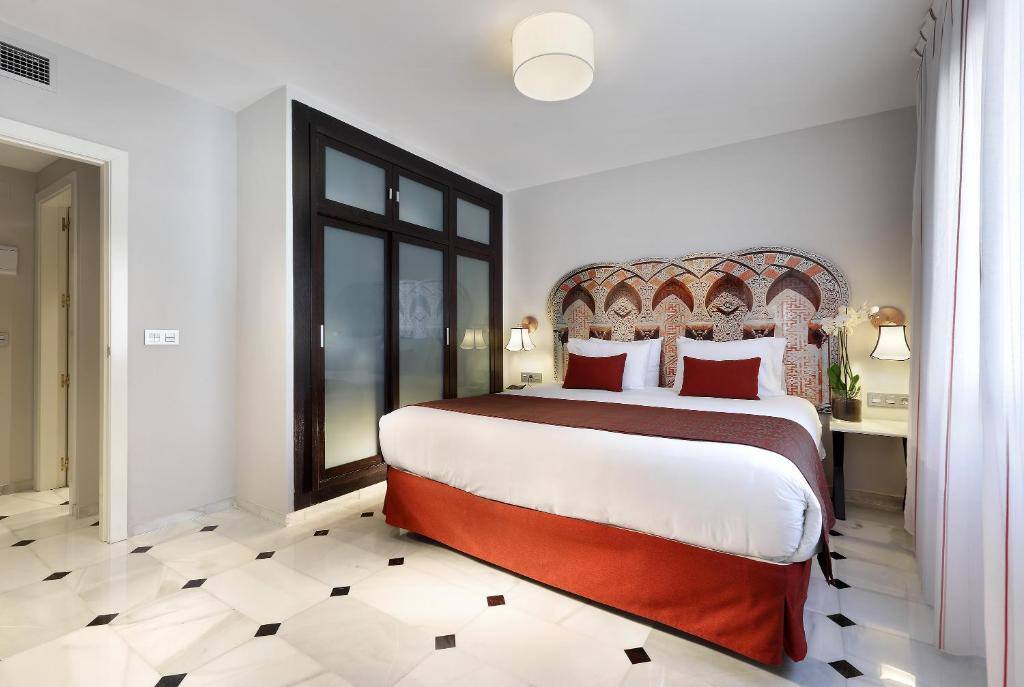 Guest room with Andalusian headboard at Eurostars Conquistador
